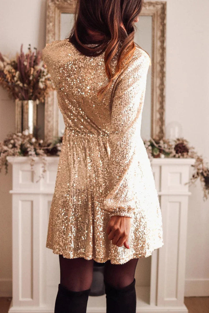 "Alexia gold sequin wrap mini dress with long sleeves, perfect for a glamorous night out."