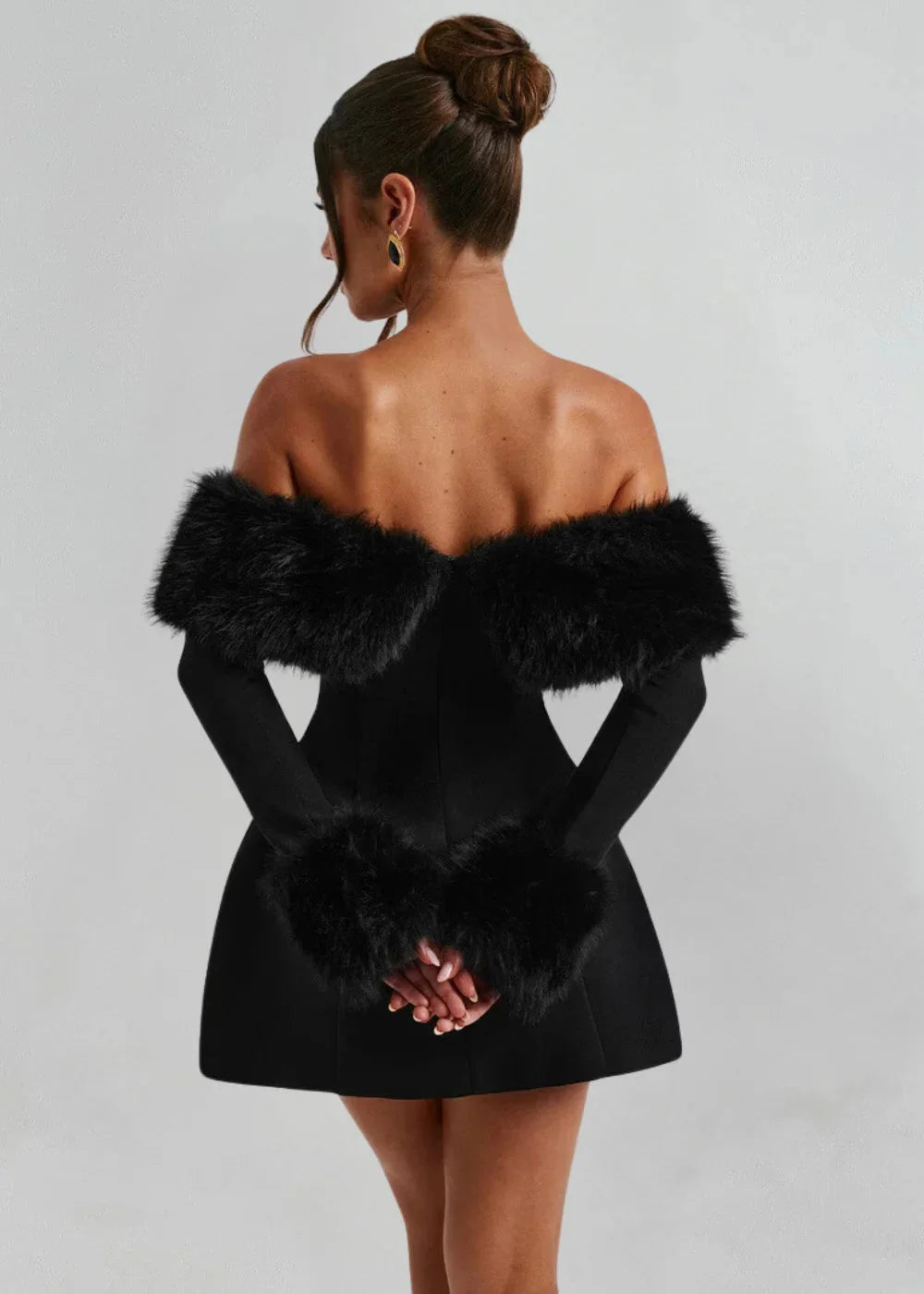 Off-shoulder black mini dress with fur accents, perfect for a chic and stylish look.