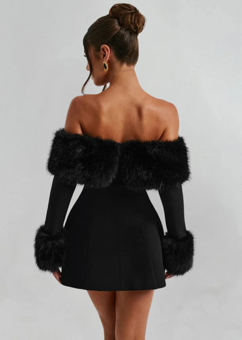 Black off-shoulder mini dress with fur accents, a chic and stylish choice for any occasion with a trendy design and elegant…