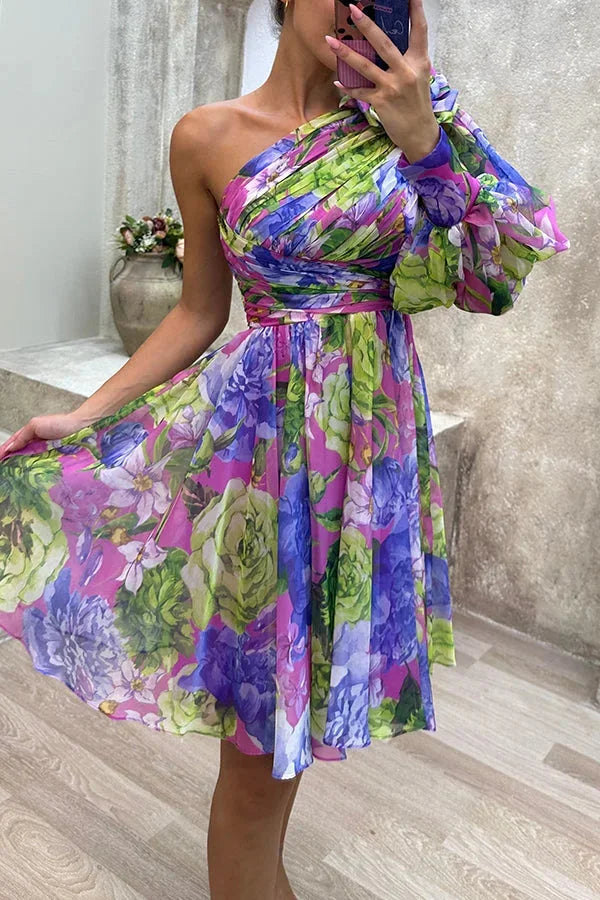 Purple asymmetrical floral dress with single sleeve, ideal for casual occasions. Made of flowy fabric with a unique stylish…