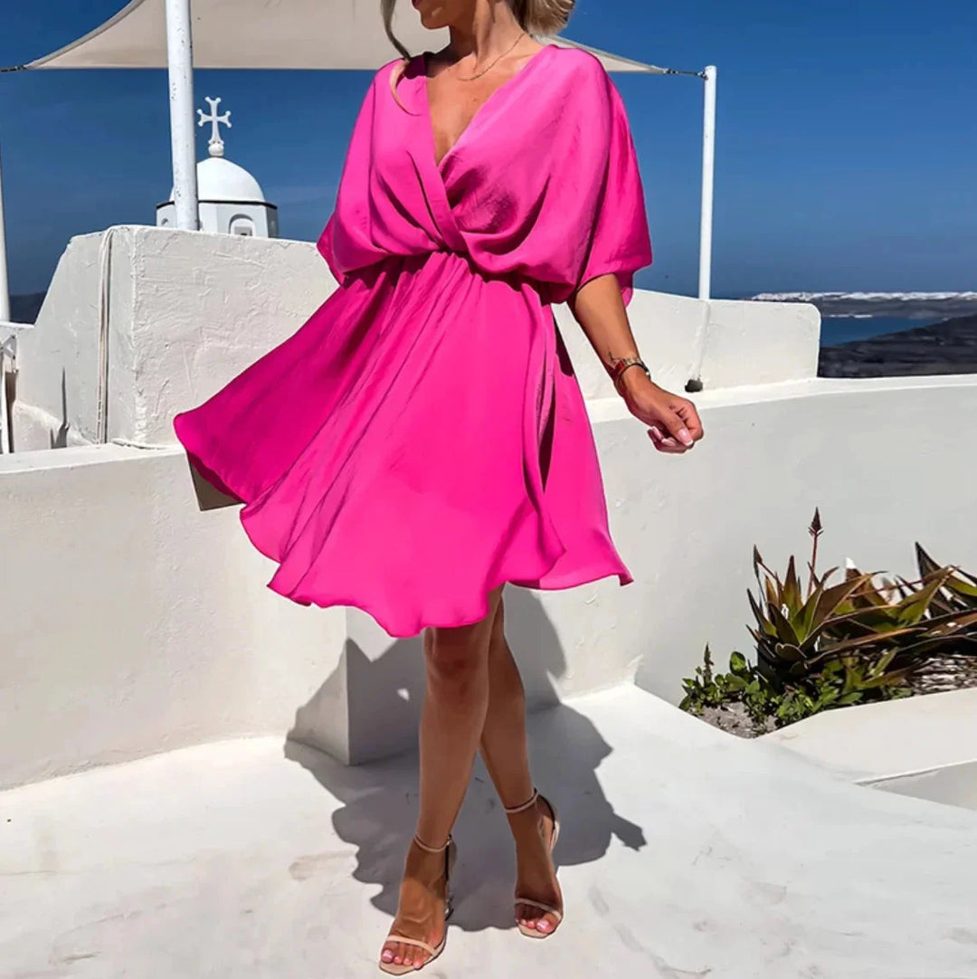 Pink wrap mini dress with a charming design featuring a V-neck and short sleeves, made of soft and flowy fabric perfect for…