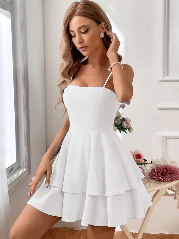 Angeline tiered mini dress with adjustable straps in soft white cotton fabric, perfect for a casual day out or date night.