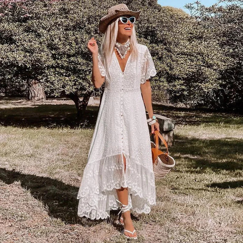 White lace high-low dress with floral pattern on bodice and sheer lace sleeves. Feminine and elegant with a trendy…