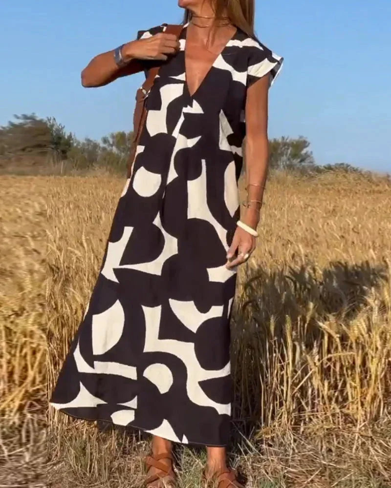 "Vibrant flowy V-neck maxi dress with bold patterns, perfect for a casual yet stylish look. Made with lightweight and…