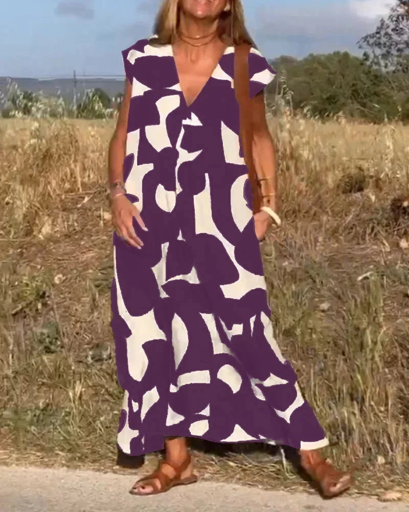 "Flowy V-neck maxi dress adorned with vibrant bold patterns for a chic and stylish look, perfect for your next summer…