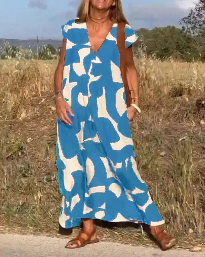 "Flowy V-neck maxi dress with vibrant patterns in a soft, comfortable fabric. Perfect for effortless style and all-day…