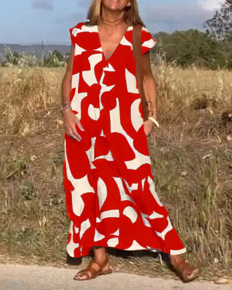 Red flowy V-neck maxi dress with a vibrant pattern. Made of lightweight and breathable fabric. Ideal for a casual and…