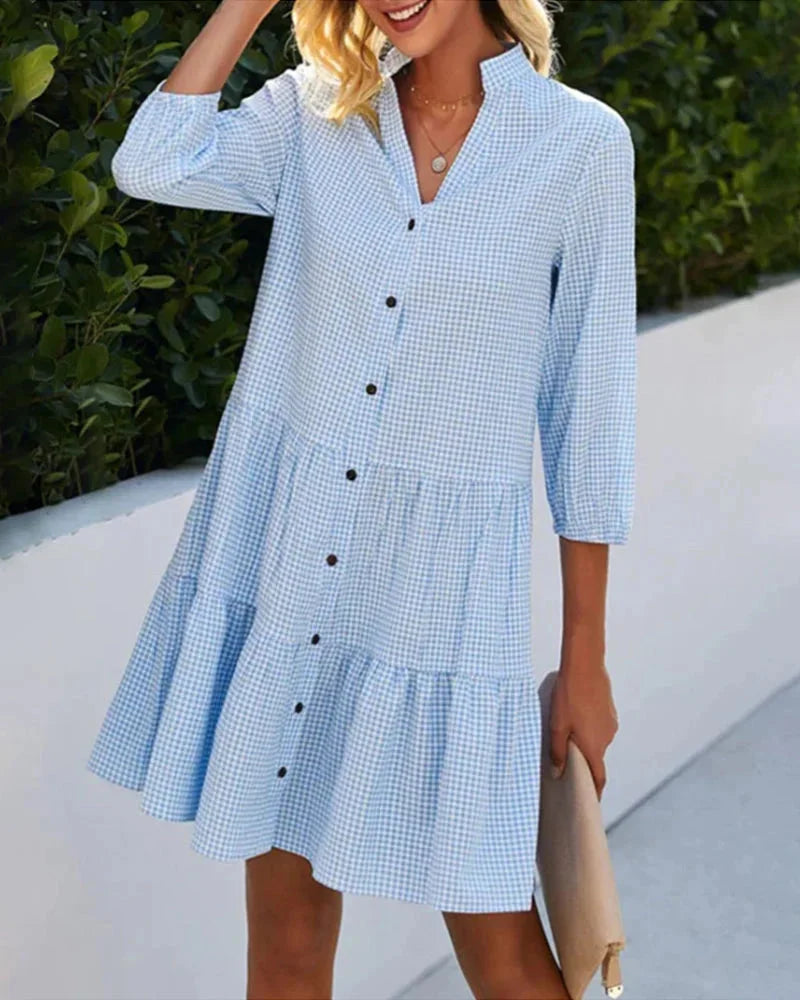 "Light blue tiered button-up midi dress with collar, made of soft cotton blend, perfect for casual occasions."