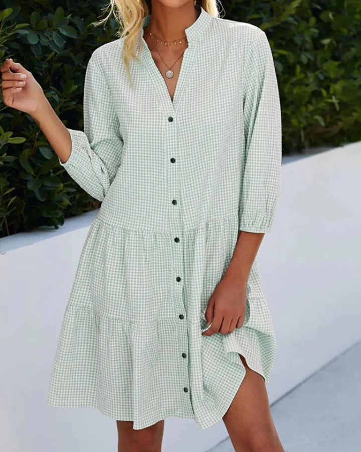 Green tiered button-up midi dress with collar made of lightweight cotton blend. Flattering silhouette with timeless design.