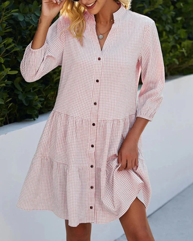 Pink tiered button-up midi dress with collar, featuring a lightweight and flowy material. Feminine and elegant design…