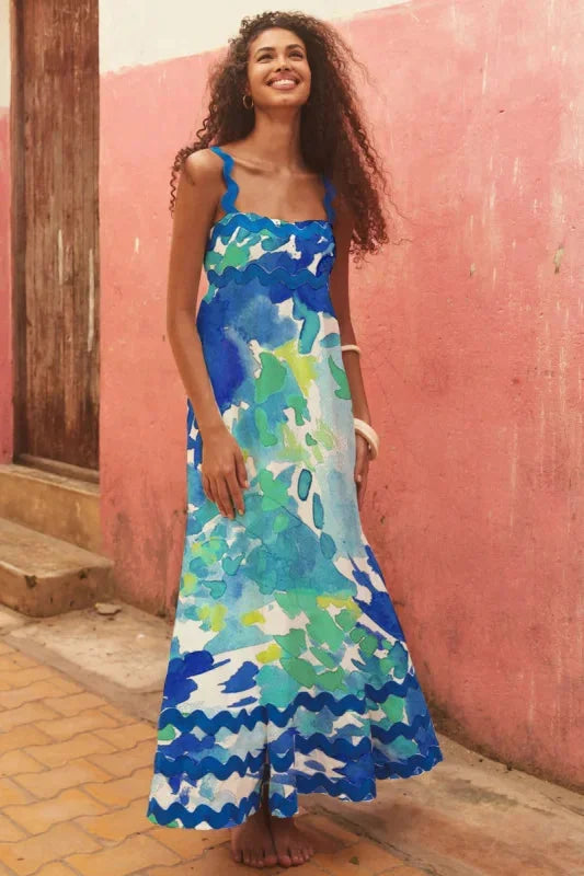 Blue green sleeveless maxi dress with wave trim in soft, flowing fabric. Ideal for casual wear or special occasions.