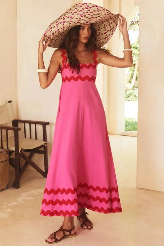 Sleeveless rose maxi dress made of flowy fabric with elegant wave trim design, perfect for casual or formal occasions.