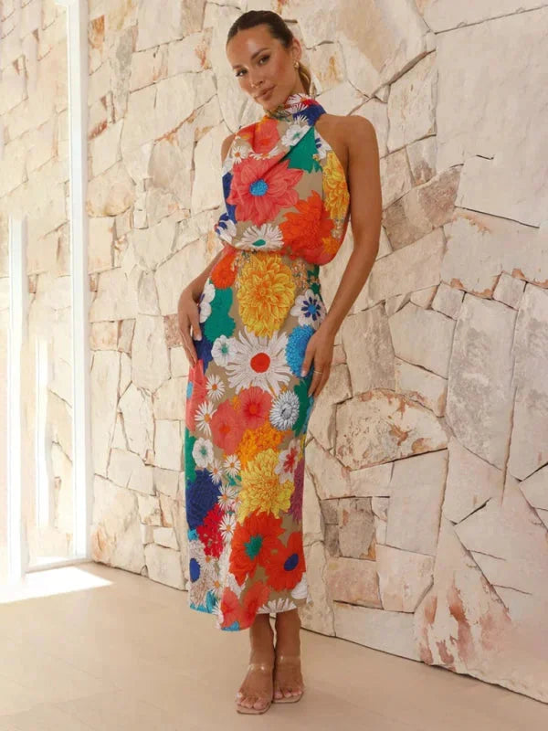 "Floral halter midi dress with vibrant colors and feminine design, perfect for a summer day out."