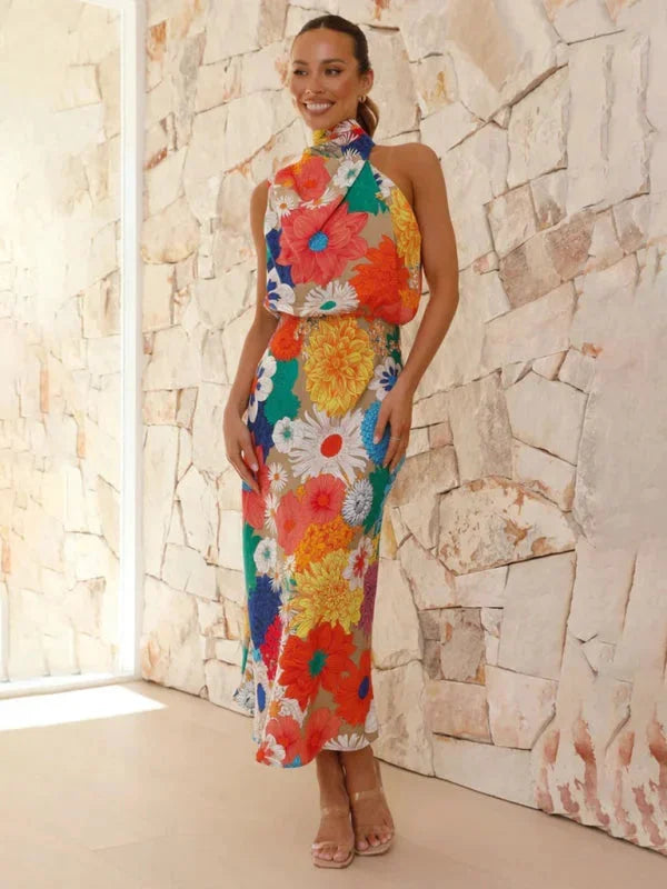 "Colorful floral halter midi dress with vibrant graphics and flowing silhouette, perfect for summer occasions."