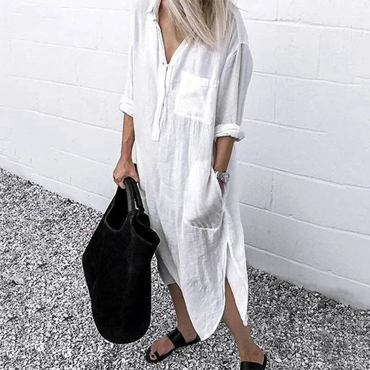 White linen dress with a relaxed-fit design, featuring a button-up front. Perfect for a casual yet stylish look in warm…