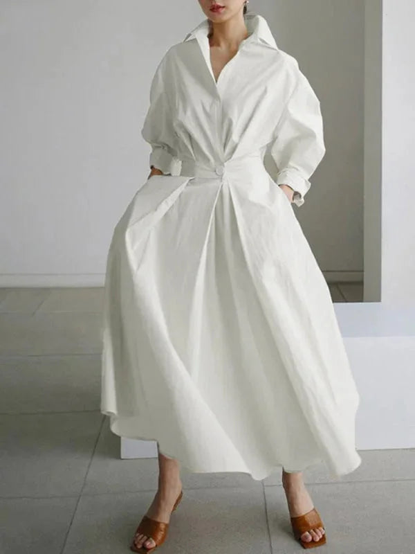 White flowing collar dress with cinched waist, made of breathable cotton blend. Perfect for a casual yet elegant look.