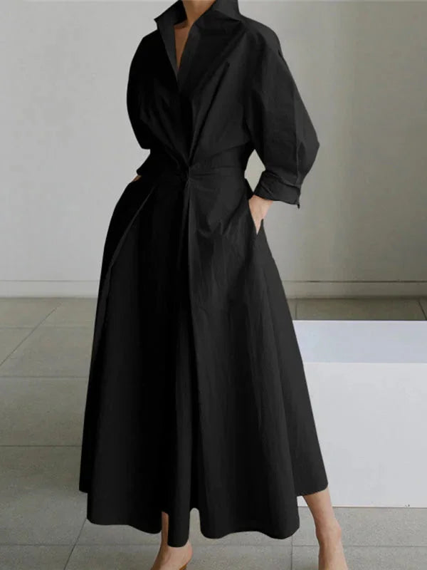 Black Britta dress with a flowing collar and cinched waist, perfect for effortless style.