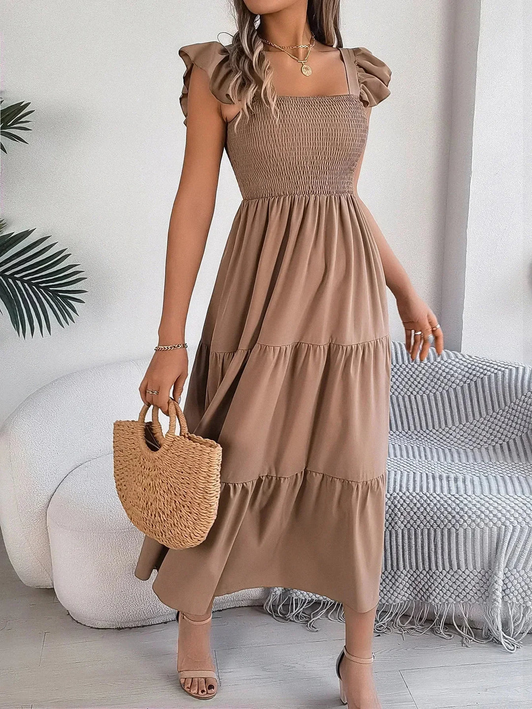 Khaki smocked midi dress with tiered ruffle detailing, ideal for a breezy summer look.