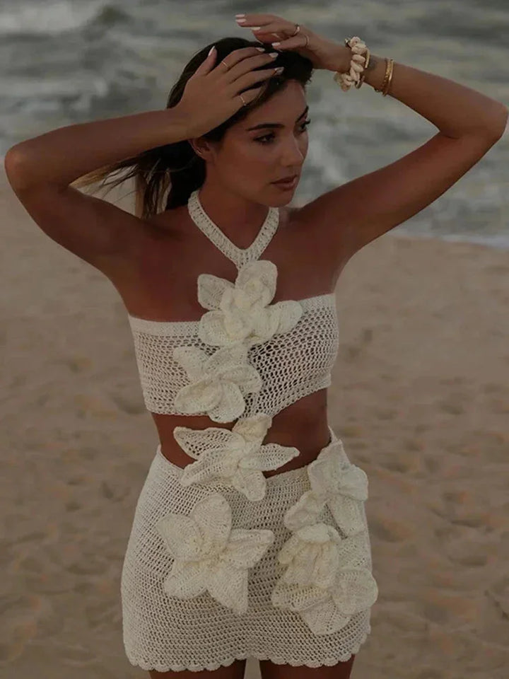 White crochet mini dress with floral detail, perfect for summer outings. High-quality fabric with intricate crochet work, a…