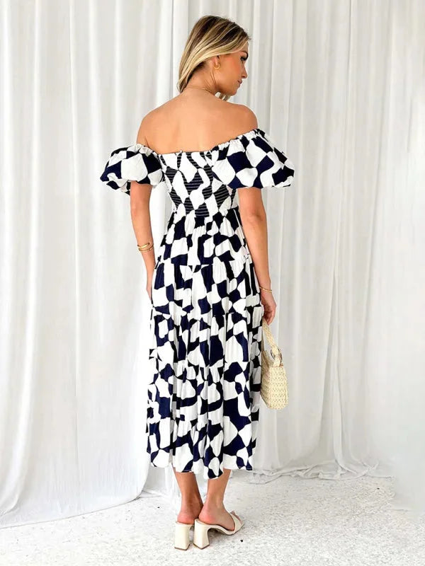 "Flowing tiered summer dress with floral pattern on a woman mannequin."