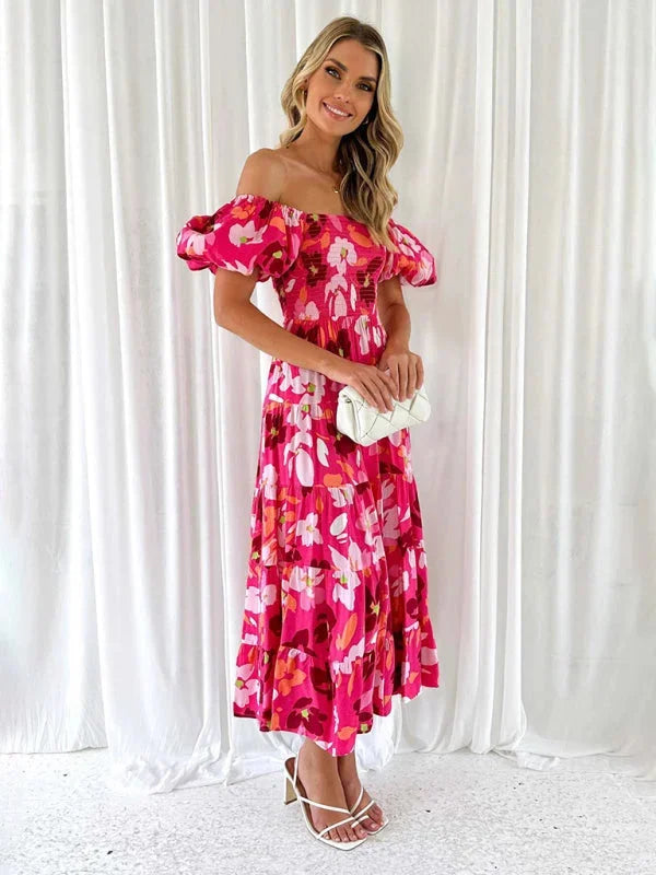 "Flowing floral tiered summer dress with a lightweight fabric in a vibrant print, perfect for sunny days and casual outings."