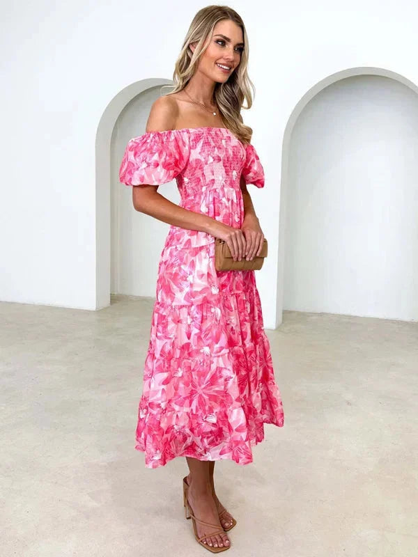 "Carmyn summer dress with tiered flowing design and floral print, perfect for summer outings and events."