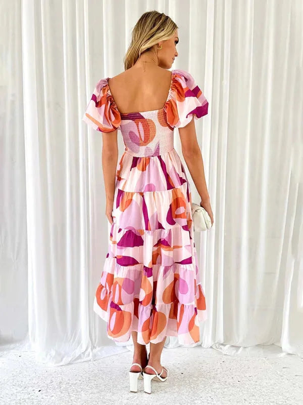 "Carmyn summer dress with flowing tiered floral pattern, perfect for a breezy look. Made from lightweight fabric in a…