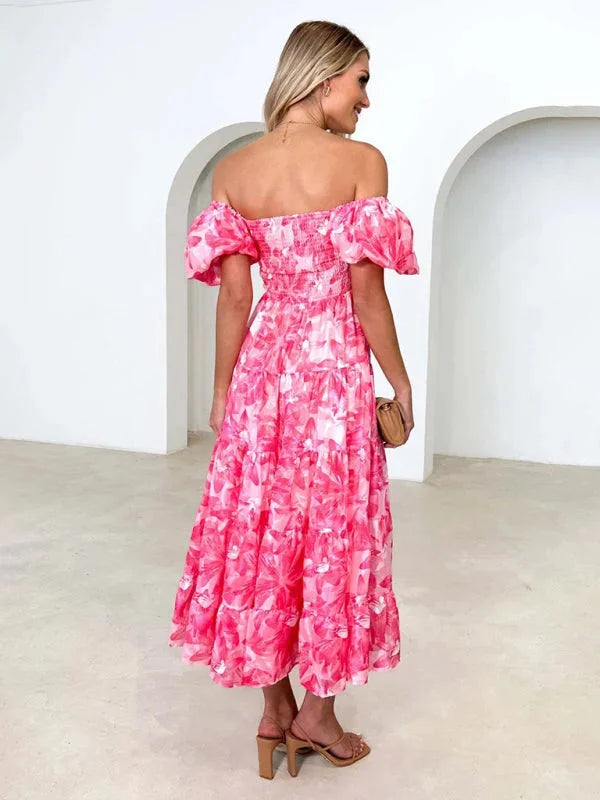 "Flowing floral tiered summer dress featuring lightweight fabric with delicate floral print, perfect for warm sunny days."