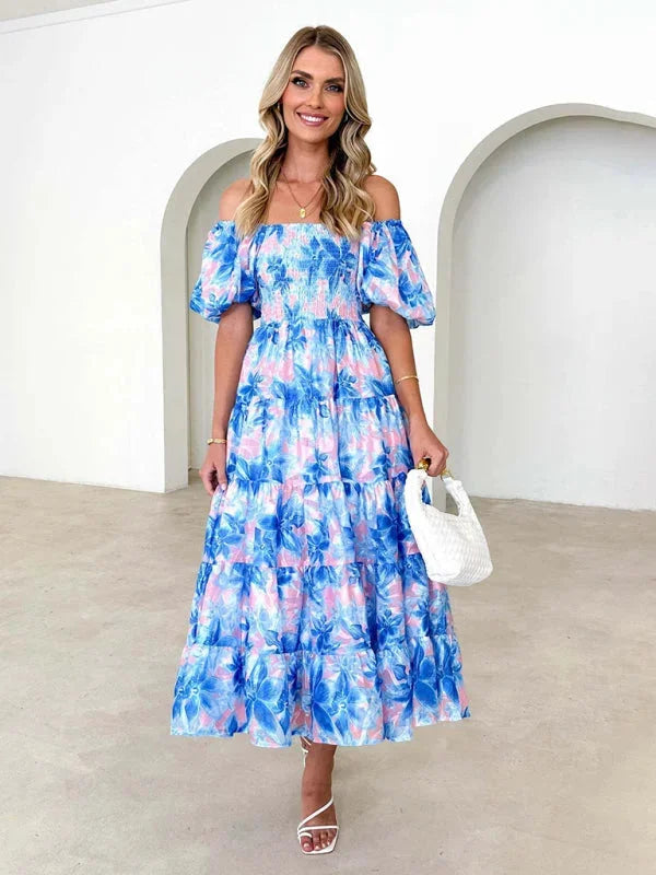 Sky blue floral tiered summer dress with a flowing design, perfect for warm days. Made from light and airy fabric for…