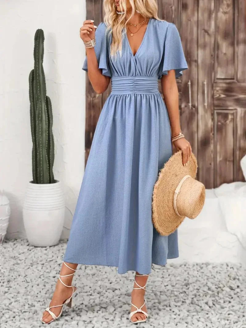 "Flowy V-neck sundress in light fabric with charming ruffled sleeves & summery aesthetic."