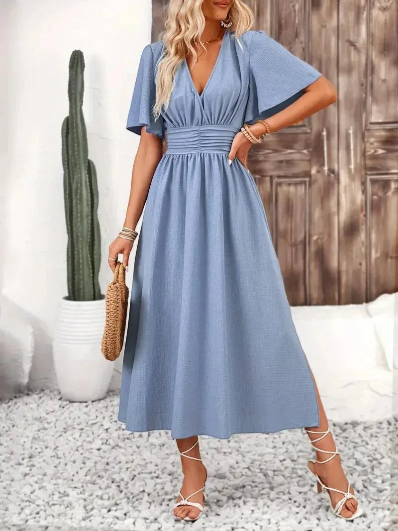 Light blue V-neck sundress with ruffled sleeves by Cimani, perfect for a casual summer day. Made of breathable and soft…