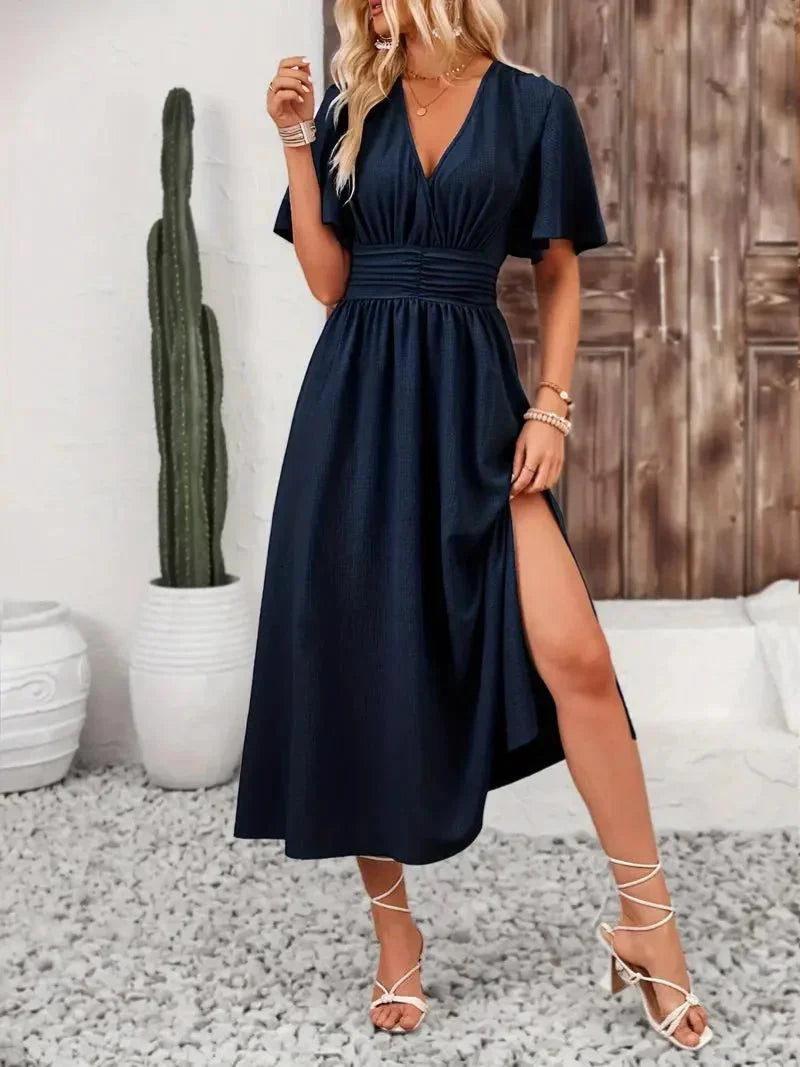 Navy blue V-neck sundress with ruffled sleeves, made from flowy fabric. Casual yet stylish design perfect for warm summer…