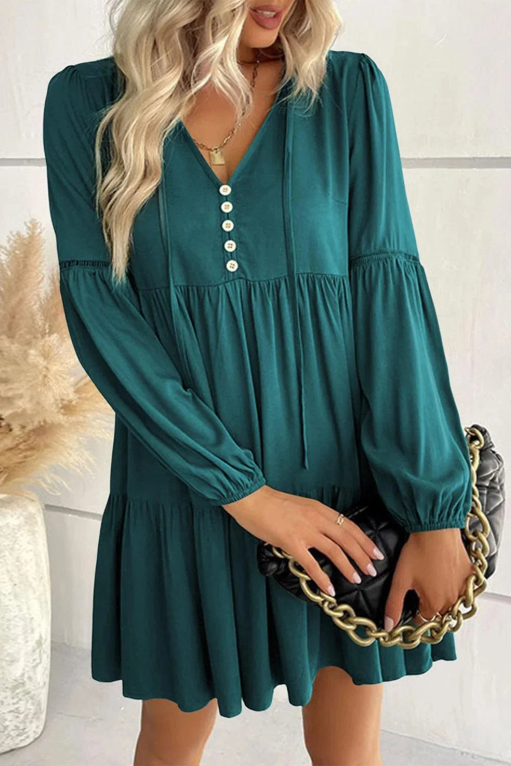 Verdant tiered mini dress with lace-up front in a charming green hue, perfect for a stylish and feminine look.