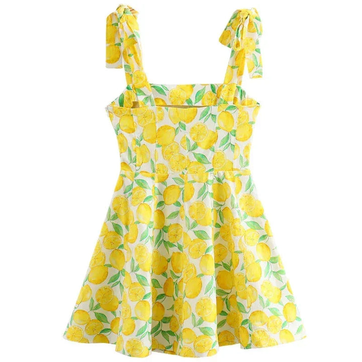 'Sleeveless yellow mini dress featuring playful lemon print, perfect for a sunny day out, made of lightweight breathable…