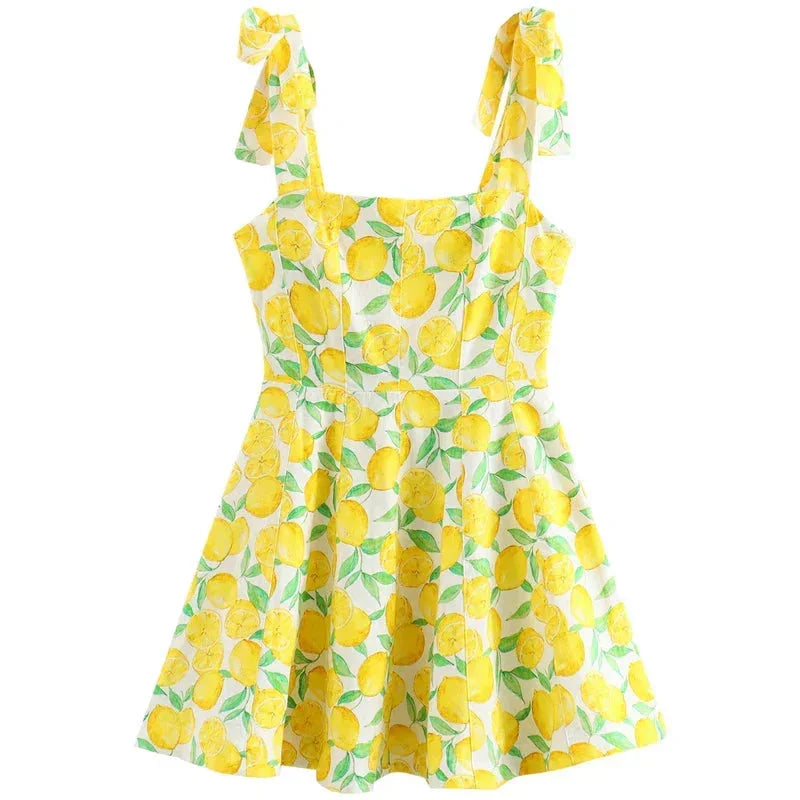 "Sleeveless yellow mini dress with lemon print, made of lightweight fabric for sunny days, perfect for a casual summer look."