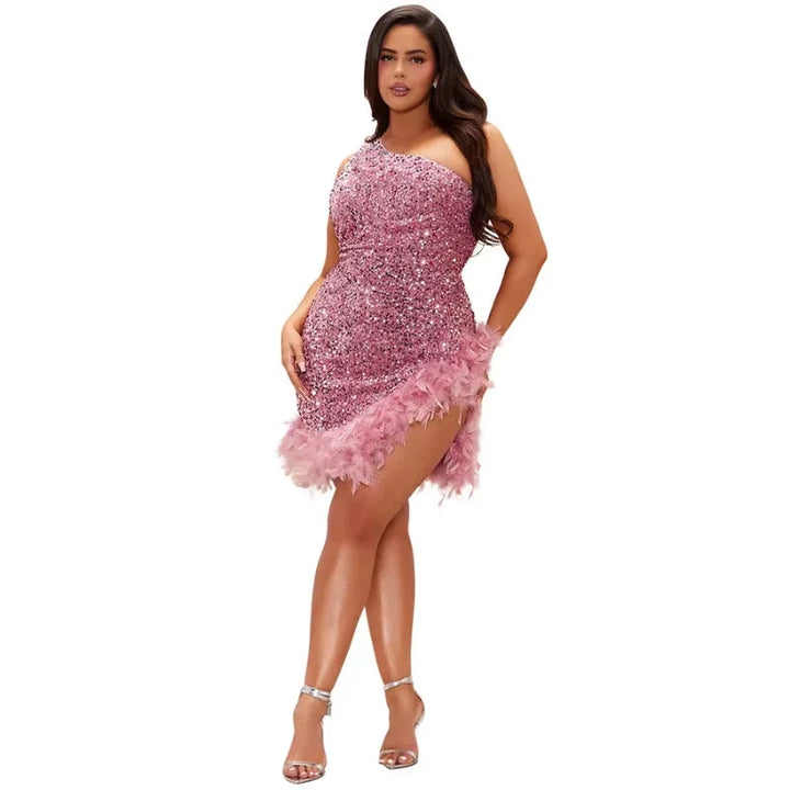 Rose glitter sequin dress with asymmetrical feather trim. Glamorous and vibrant night-out attire for a standout look.