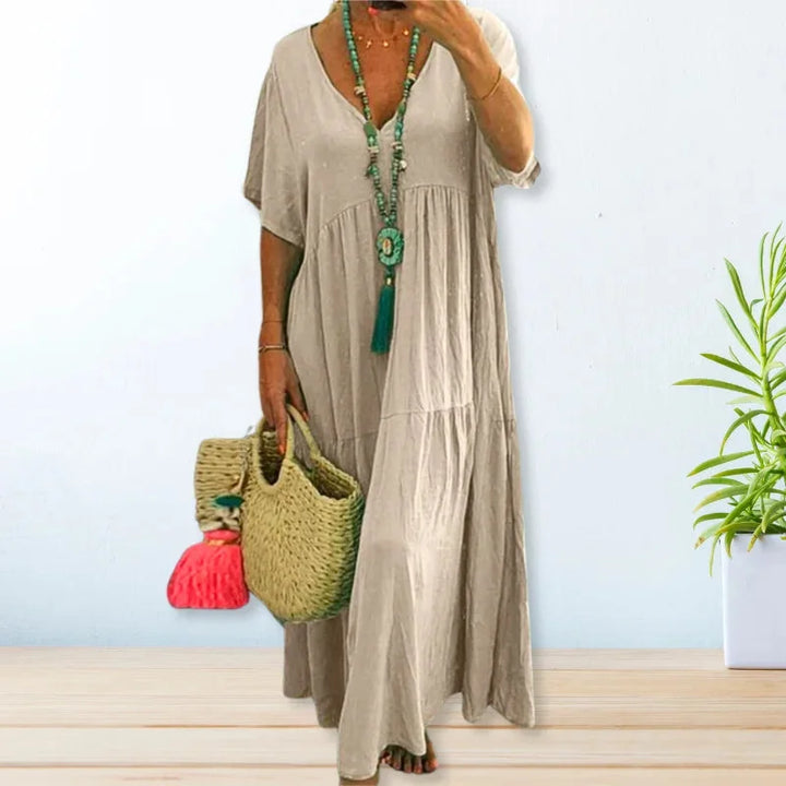 "Dana maxi dress in lightweight fabric with a flattering V-neck design, perfect for summer outings."