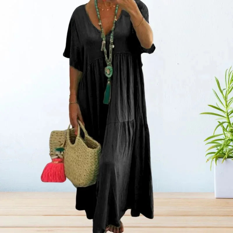 Black V-neck maxi dress by Dana, perfect for summer. Made with lightweight fabric, featuring a flattering design with a…