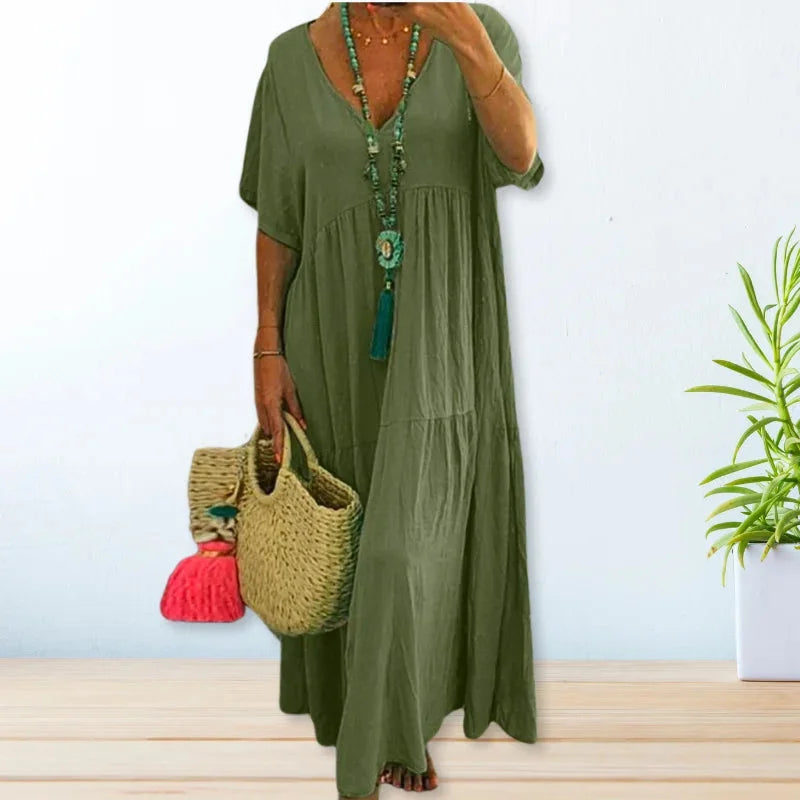 Green V-neck maxi dress for summer made of lightweight fabric. Perfect for casual outings under the sun.