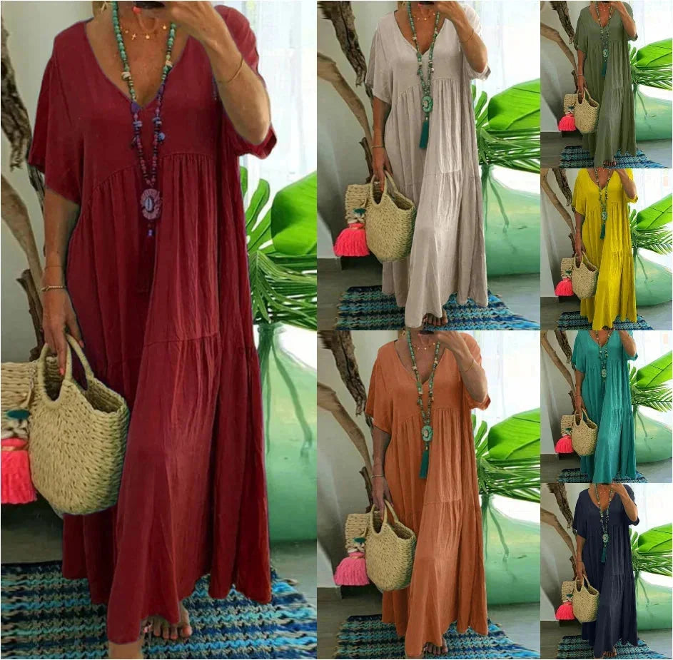 Red V-neck maxi dress made from lightweight, breathable fabric for summer. Flowy design perfect for sunny days.