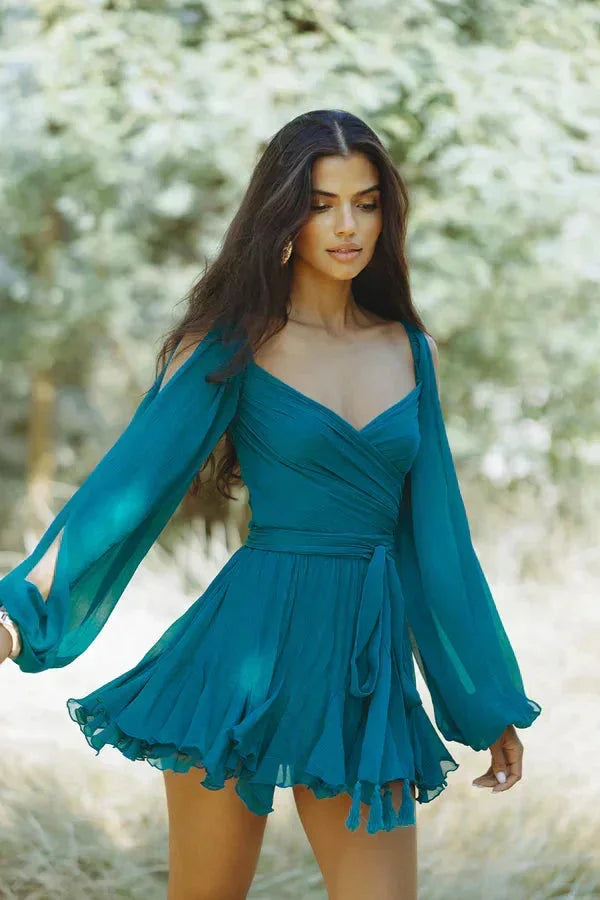 Dark teal flowy mini dress with ruffled sleeves, perfect for a casual chic look. Made from lightweight and breathable…