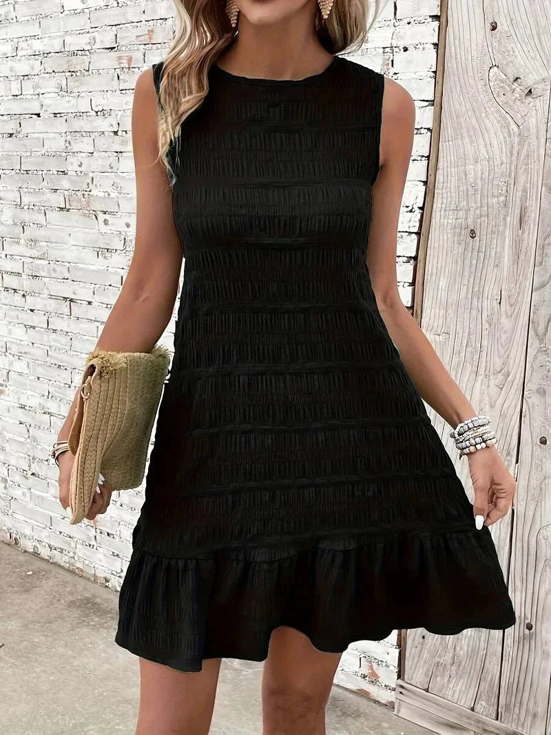 "Sleeveless textured black dress with flared hem, offering a chic and versatile addition to your wardrobe."