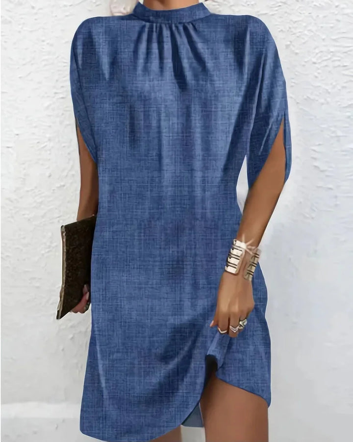 Blue mini dress with batwing sleeves, pleated neckline. Made of lightweight, flowing fabric.