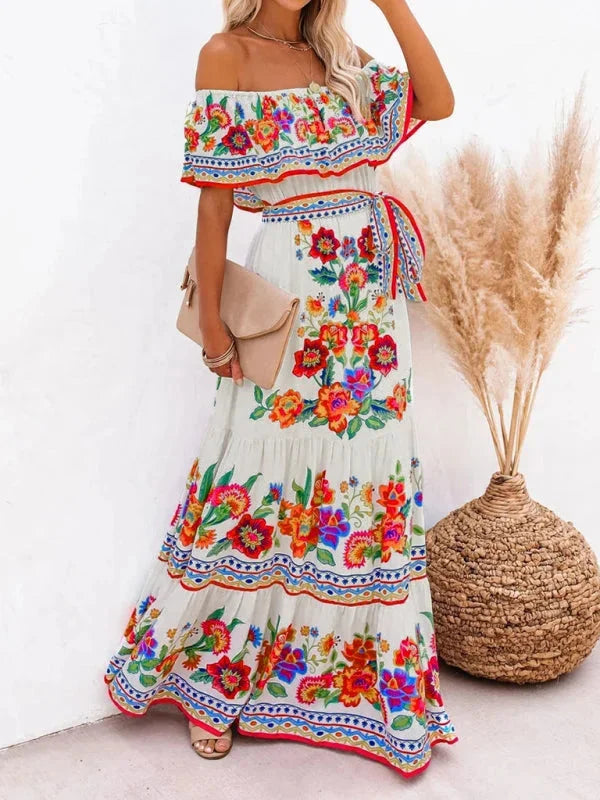 "Emiko maxi dress with floral print, tiered design, and belt detail in lightweight fabric, perfect for summer outings."