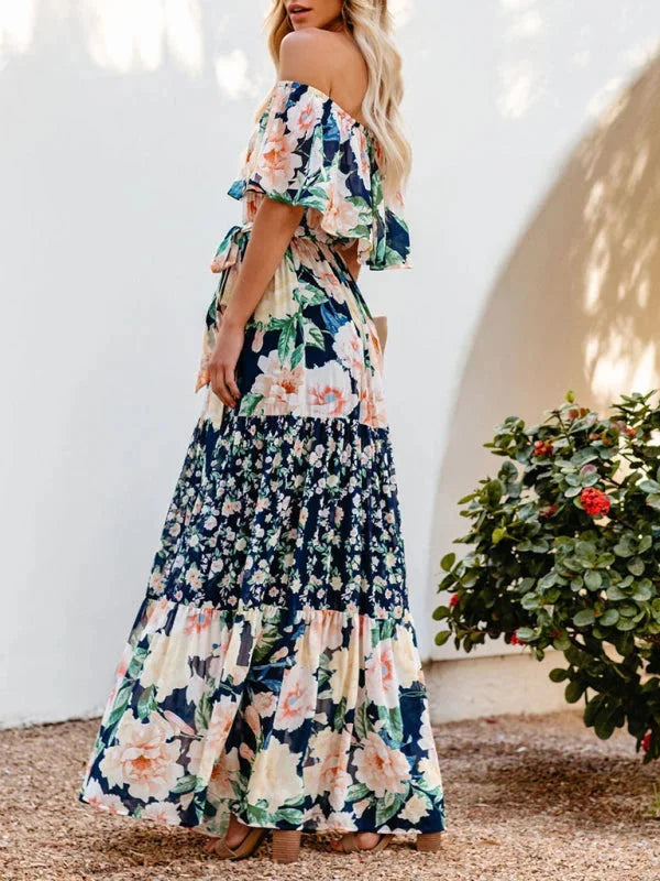 Floral tiered maxi dress with belt in a flowy silhouette, featuring vibrant floral prints and a waist-accentuating belt.