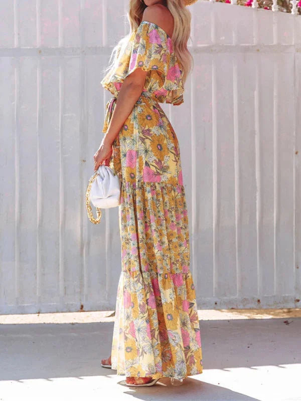 "Floral tiered maxi dress with belt in light and airy fabric, featuring a vibrant floral print and flattering tiered design."