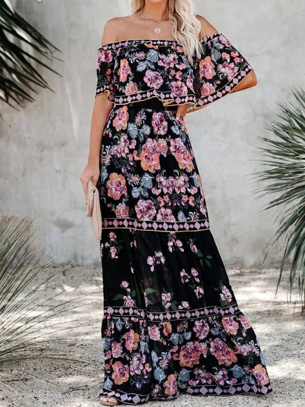 "Black tiered maxi dress with floral pattern, belt detail, and lightweight fabric."