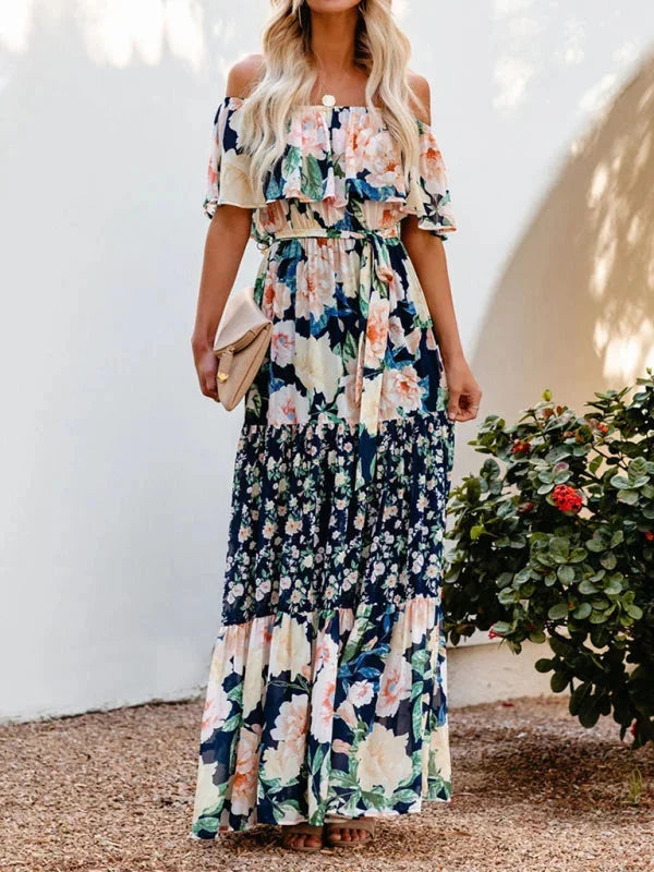 Blue floral tiered maxi dress with belt, made from lightweight and airy fabric. Features a flattering tiered design for a…