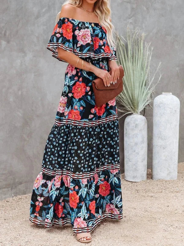 Dark blue tiered maxi dress with belt featuring a floral pattern. Perfect for a boho chic look with its flowy design.