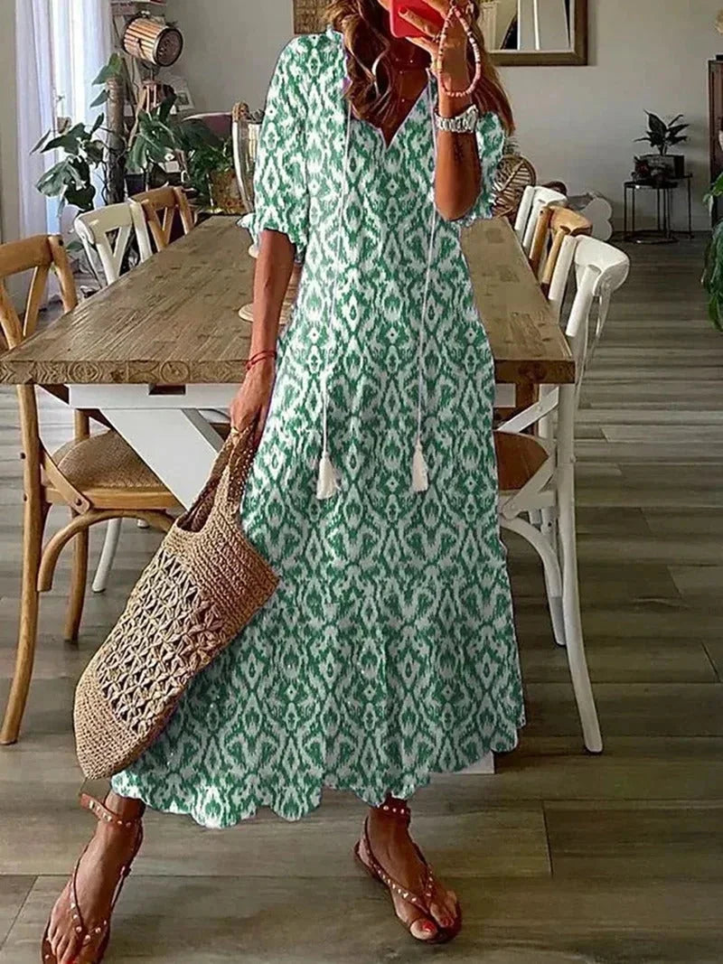 Green floral maxi dress with elbow sleeves, made from soft and breathable fabric. Perfect for a casual and stylish look.